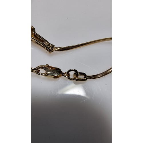 423 - Hallmarked 9ct yellow gold necklace with a two tone yellow and white gold pendant inset with three s... 