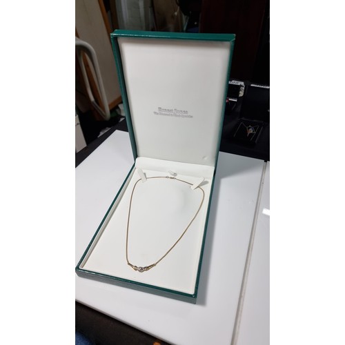 423 - Hallmarked 9ct yellow gold necklace with a two tone yellow and white gold pendant inset with three s... 