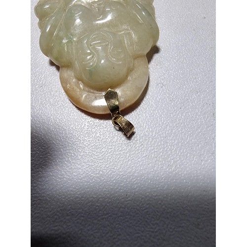 406 - A well carved solid jade Buddha pendant with a 9ct gold bale, in excellent condition, tested as jade... 