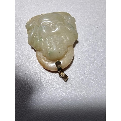 406 - A well carved solid jade Buddha pendant with a 9ct gold bale, in excellent condition, tested as jade... 