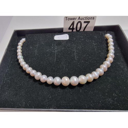 407 - A fine quality natural sea pearl (not cultured) beaded necklace with graduated beads featuring an im... 