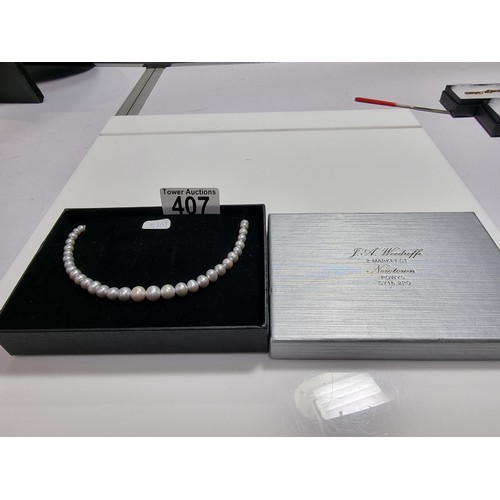 407 - A fine quality natural sea pearl (not cultured) beaded necklace with graduated beads featuring an im... 