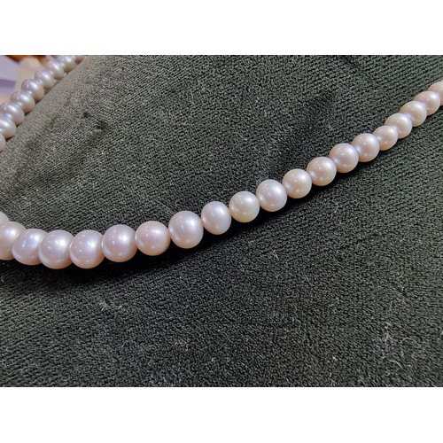 407 - A fine quality natural sea pearl (not cultured) beaded necklace with graduated beads featuring an im... 