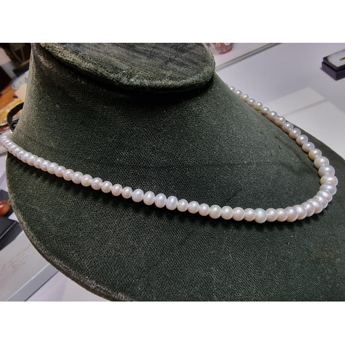 407 - A fine quality natural sea pearl (not cultured) beaded necklace with graduated beads featuring an im... 