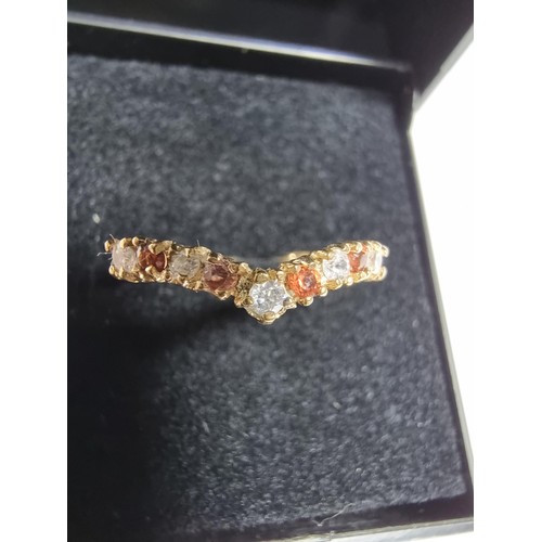 405 - A hallmarked 9ct yellow gold wishbone ring inset with orange and white cz crystal stones. In excelle... 