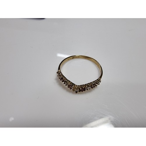 405 - A hallmarked 9ct yellow gold wishbone ring inset with orange and white cz crystal stones. In excelle... 