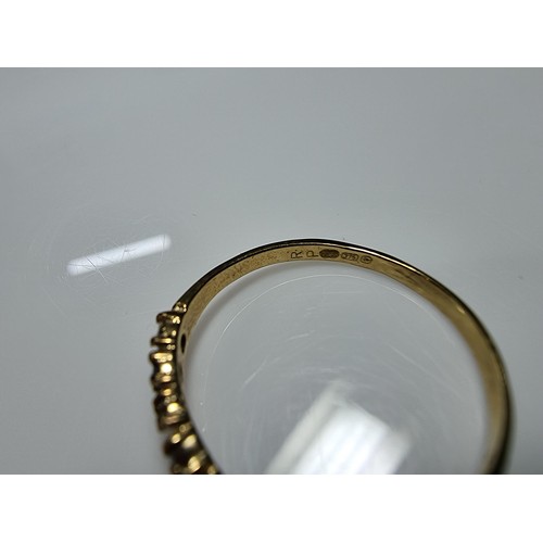 405 - A hallmarked 9ct yellow gold wishbone ring inset with orange and white cz crystal stones. In excelle... 