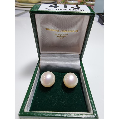 413 - A pair of 9ct yellow gold large genuine pearl stud earrings complete with butterfly backs in good co... 