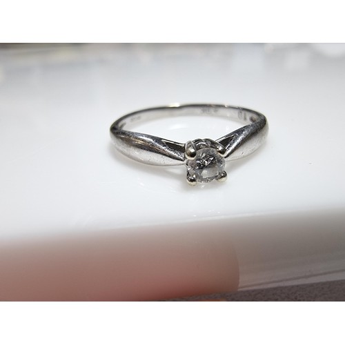 414 - A hallmarked 9ct white gold solitaire diamond ring inset with a 0.10 ct diamond which is sparkly and... 