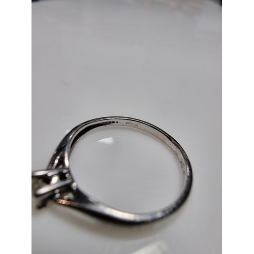 414 - A hallmarked 9ct white gold solitaire diamond ring inset with a 0.10 ct diamond which is sparkly and... 