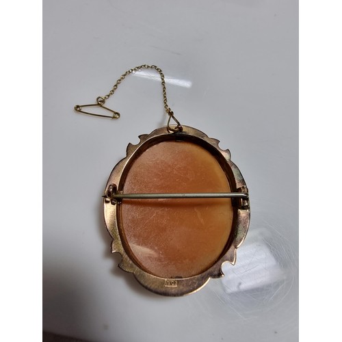 416 - An ornate 9ct yellow gold carved shell cameo brooch with a portrait of a lady looking right.
In exce... 