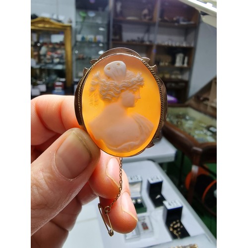416 - An ornate 9ct yellow gold carved shell cameo brooch with a portrait of a lady looking right.
In exce... 
