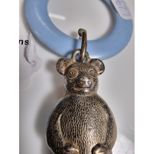 424 - A tested as sterling silver antique babies teething ring with a sterling silver teddy rattle in very... 