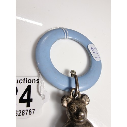 424 - A tested as sterling silver antique babies teething ring with a sterling silver teddy rattle in very... 