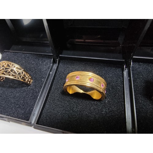 353 - 3 x boxed attractive dress rings including a ring with pink gems all the way around a pierced ring a... 