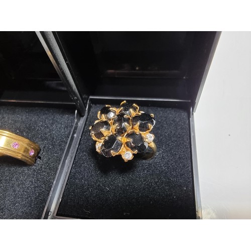 353 - 3 x boxed attractive dress rings including a ring with pink gems all the way around a pierced ring a... 