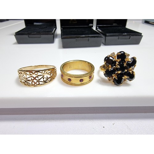 353 - 3 x boxed attractive dress rings including a ring with pink gems all the way around a pierced ring a... 