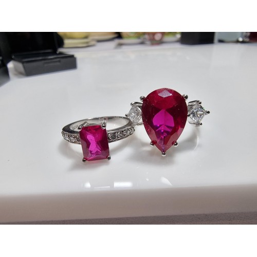 354 - 2 x pretty dress rings, both 18 ct gold plated.
Both rings are inset with a large pink sapphire ston... 