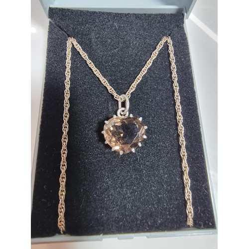 355 - A 925 silver pendant inset with a large faceted heart formed smokey quartz gemstone. Set on a 16