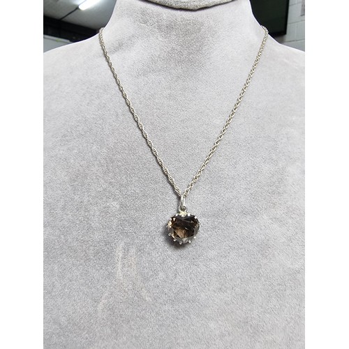 355 - A 925 silver pendant inset with a large faceted heart formed smokey quartz gemstone. Set on a 16