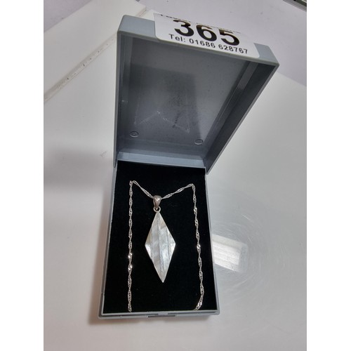 365 - A 925 silver and mother of pearl pendant with an attractive design. Set on a long 24