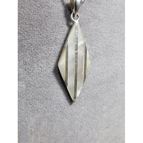 365 - A 925 silver and mother of pearl pendant with an attractive design. Set on a long 24