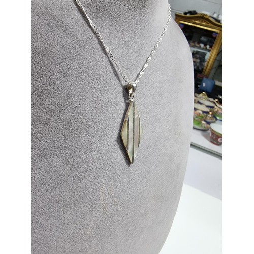 365 - A 925 silver and mother of pearl pendant with an attractive design. Set on a long 24