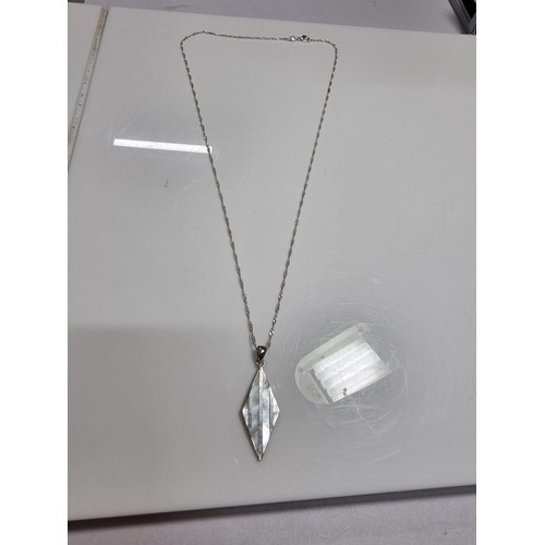 365 - A 925 silver and mother of pearl pendant with an attractive design. Set on a long 24