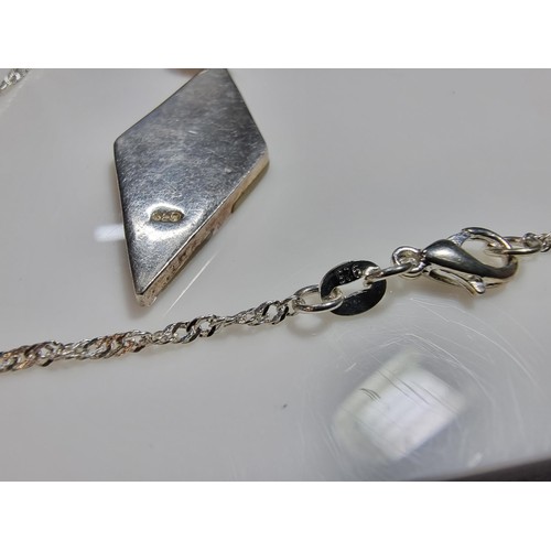 365 - A 925 silver and mother of pearl pendant with an attractive design. Set on a long 24
