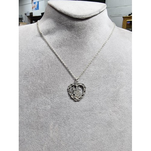 367 - A 925 silver part formed St Christopher pendant. Set on a 20