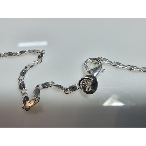 374 - A large 925 silver m.o.p. pendant with an unusual natural design, set on a very long 26