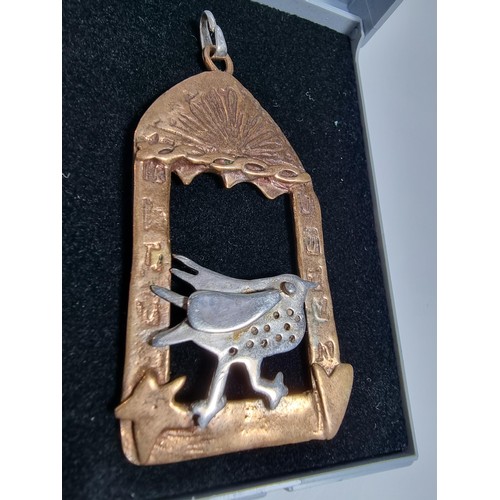 376 - An unusual vintage arts & crafts copper and pewter large pendant of a bird in an archway scene. Engr... 