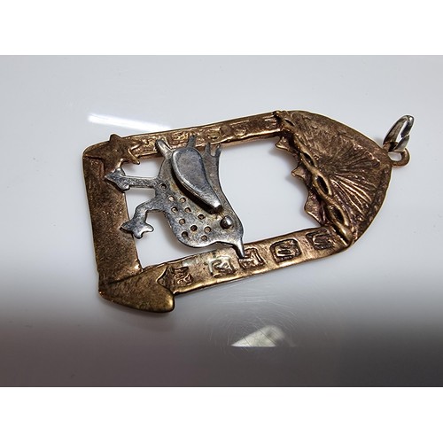 376 - An unusual vintage arts & crafts copper and pewter large pendant of a bird in an archway scene. Engr... 