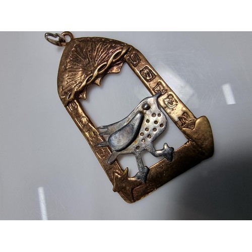 376 - An unusual vintage arts & crafts copper and pewter large pendant of a bird in an archway scene. Engr... 