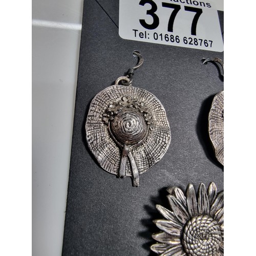 377 - A pair of 925 silver hat formed drop earrings, along with a silver plated sunflower pendant.