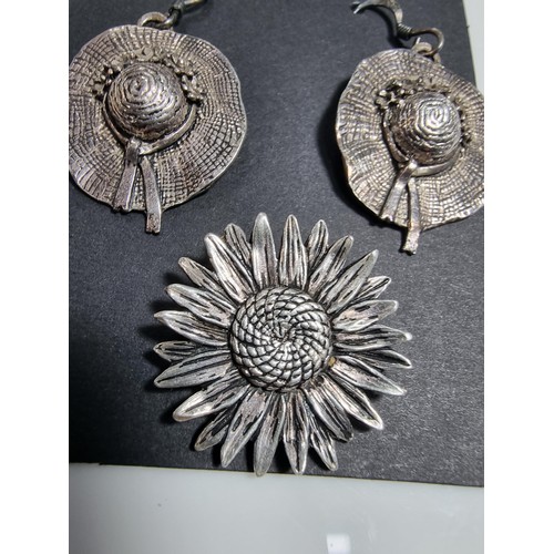377 - A pair of 925 silver hat formed drop earrings, along with a silver plated sunflower pendant.