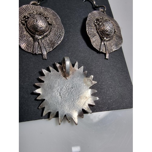 377 - A pair of 925 silver hat formed drop earrings, along with a silver plated sunflower pendant.