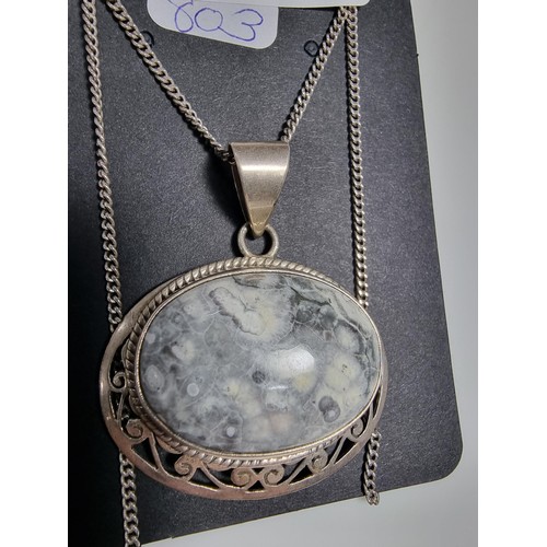 378 - A 925 large silver pendant inset with a large oval ocean jasper gemstone with an interest in natural... 