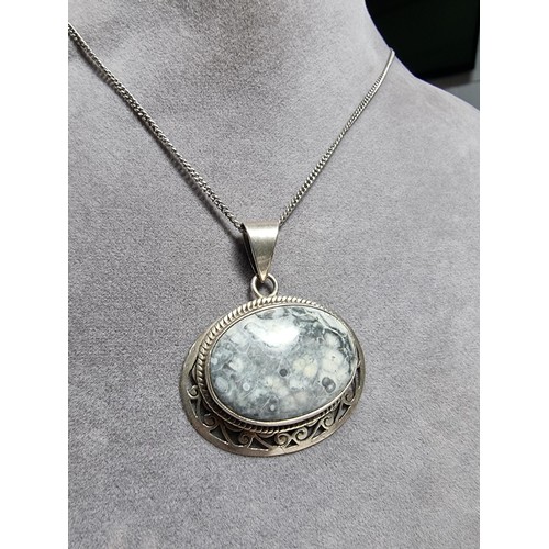 378 - A 925 large silver pendant inset with a large oval ocean jasper gemstone with an interest in natural... 