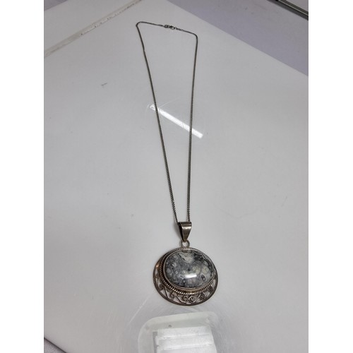 378 - A 925 large silver pendant inset with a large oval ocean jasper gemstone with an interest in natural... 