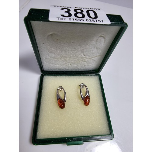 380 - A pair of 925 silver earrings inset with genuine Baltic amber stones marked 925. Boxed, in clean con... 