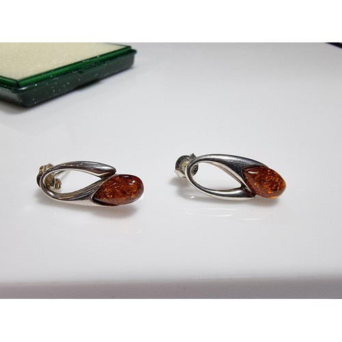 380 - A pair of 925 silver earrings inset with genuine Baltic amber stones marked 925. Boxed, in clean con... 