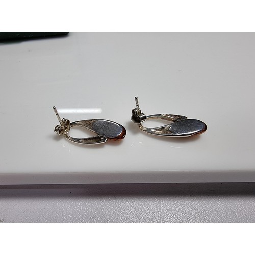 380 - A pair of 925 silver earrings inset with genuine Baltic amber stones marked 925. Boxed, in clean con... 