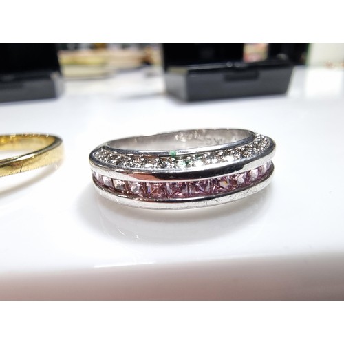 383 - 2 ornate costume dress rings including a 10ct gold filled ring inset with a quantity of pink stones.... 