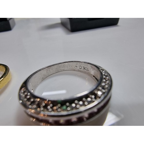 383 - 2 ornate costume dress rings including a 10ct gold filled ring inset with a quantity of pink stones.... 