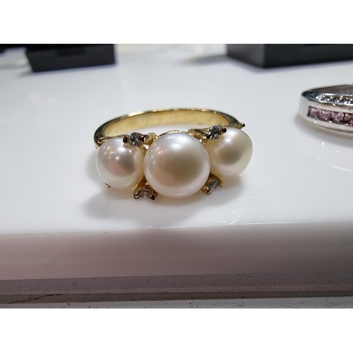 383 - 2 ornate costume dress rings including a 10ct gold filled ring inset with a quantity of pink stones.... 