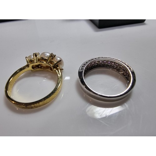 383 - 2 ornate costume dress rings including a 10ct gold filled ring inset with a quantity of pink stones.... 