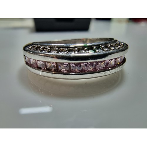 383 - 2 ornate costume dress rings including a 10ct gold filled ring inset with a quantity of pink stones.... 