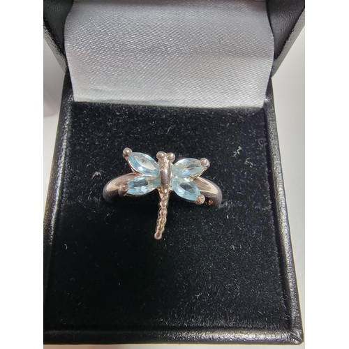 384 - A new old stock 925 silver dragonfly ring inset with blue stones.
size P, in a new quality ring box.