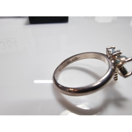 384 - A new old stock 925 silver dragonfly ring inset with blue stones.
size P, in a new quality ring box.